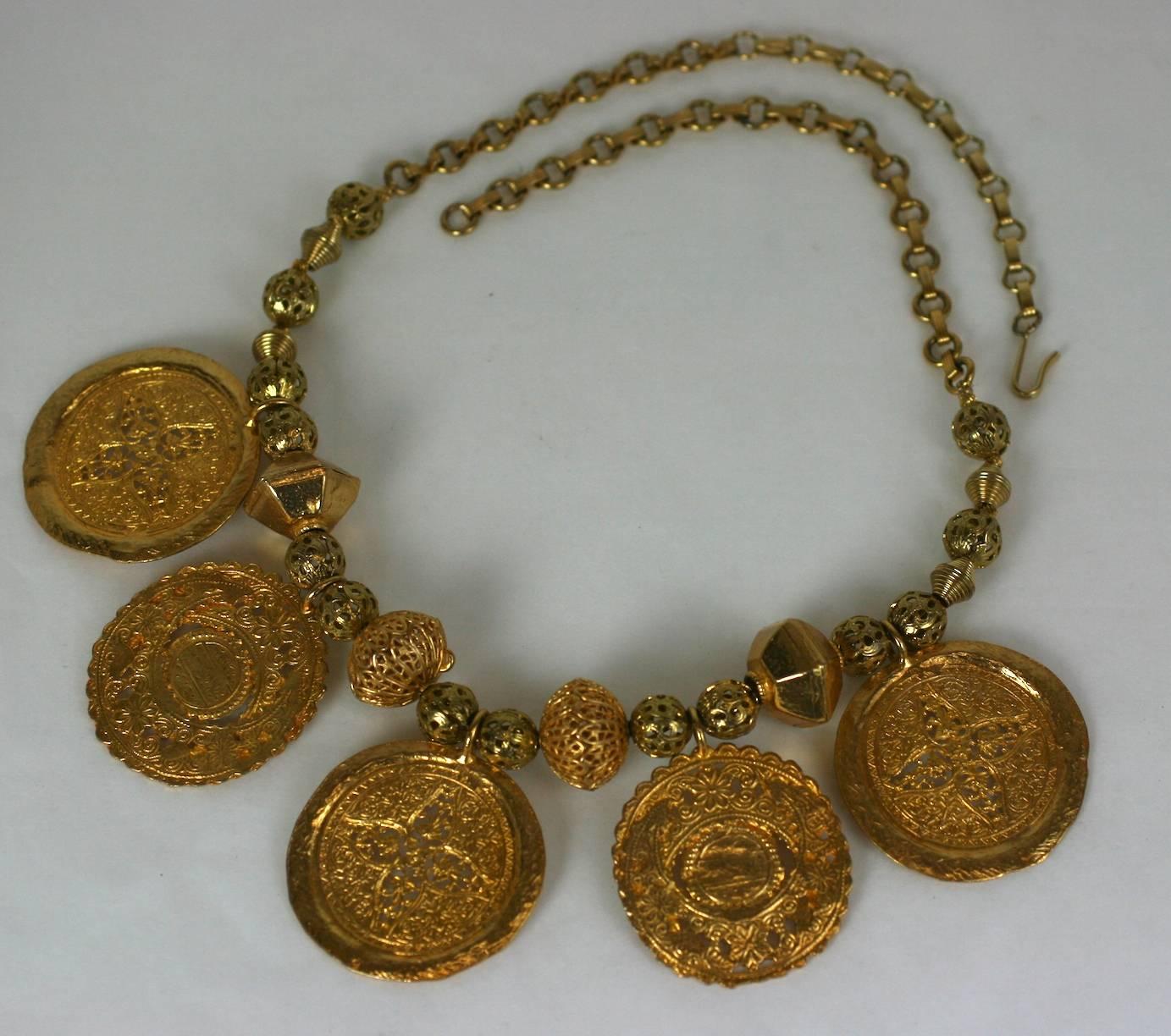 Elegant Kenneth Jay Lane Ancient Medallion Necklace in the Moroccan style with rich gold bead spacers and long adjustable chain. 1980's USA. 
25