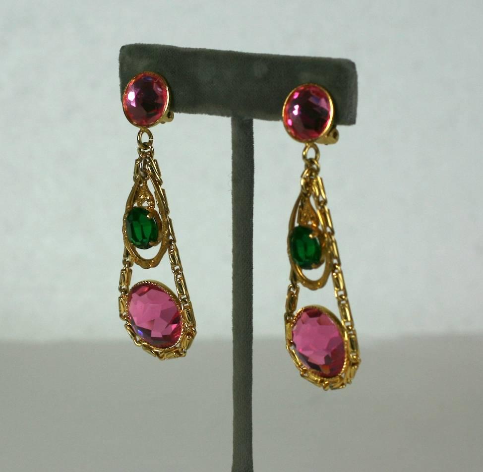 French long earrings in a Girandole style of faux pink tourmaline and emerald faceted, rose cut crystal. 
Earring pendants are articulated and set in gilt metal. Clip back fittings. 1950's France. 
Excellent Condition.
Length 2.75