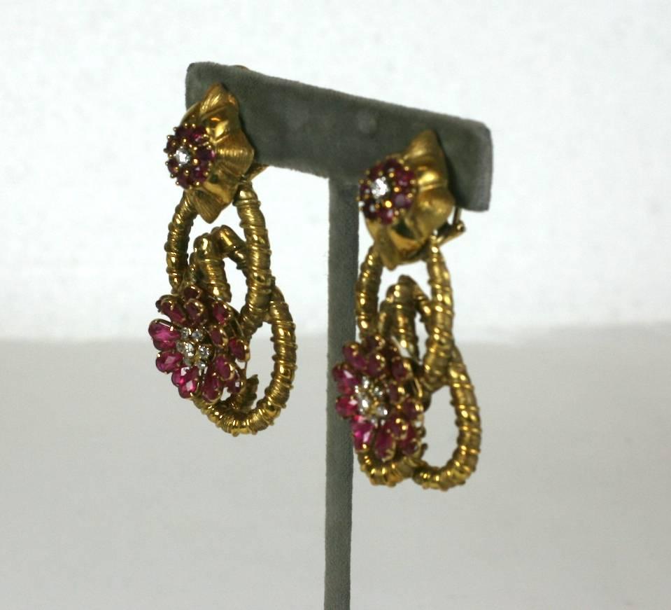 Large and striking 18k Ruby and Diamond Flower Earrings, of rose cut pear shaped ruby petals    with round diamond accents. 
Elaborately twisted and interlaced ribbed 18k gold settings with beautiful rubies and diamonds. Lovely quality and