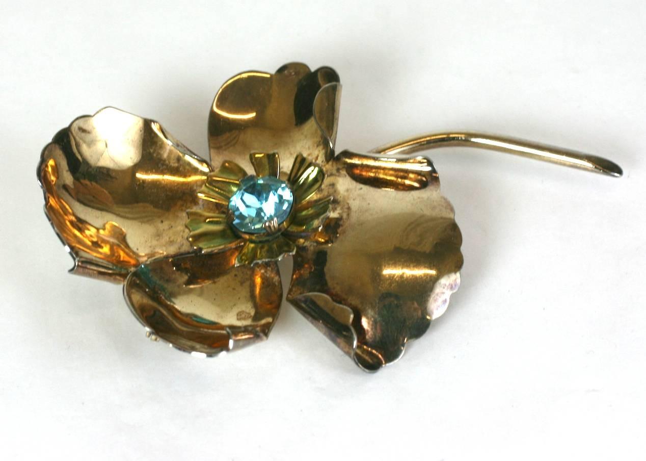 Large 1940's retro unfurling poppy brooch of gold washed sterling silver with faux blue zircon  crystal. 
The naturalistic flower with retro details is large and dimensional, but, not heavy. 
Marked Sterling, 1940's USA.
Excellent Condition.
Height