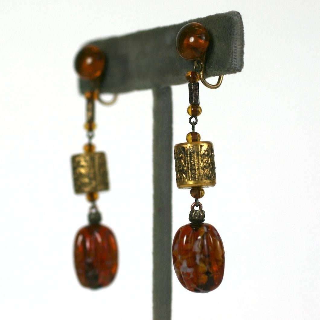 Louis Rousselet Art Deco faux citrine pate de verre and gilt long earrings. Of small round and large mellon cut beads with incised gilt barrel shape beads and spacers. 
Marked France. Screwback Fittings.
Excellent Condition.
Length 2.25