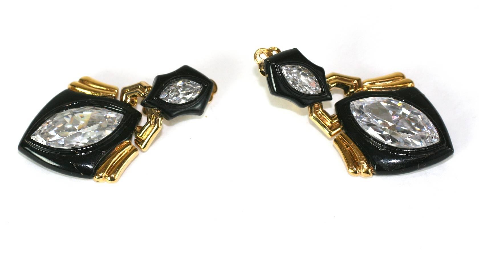 Angela Kramer was a fine jeweler who also designed costume jewelry in the 1990's. Her designs were similar to Marina B and Bulgari designs of the day. 
In these dangle earrings, she uses black enamel against gold plated metal and sets them with