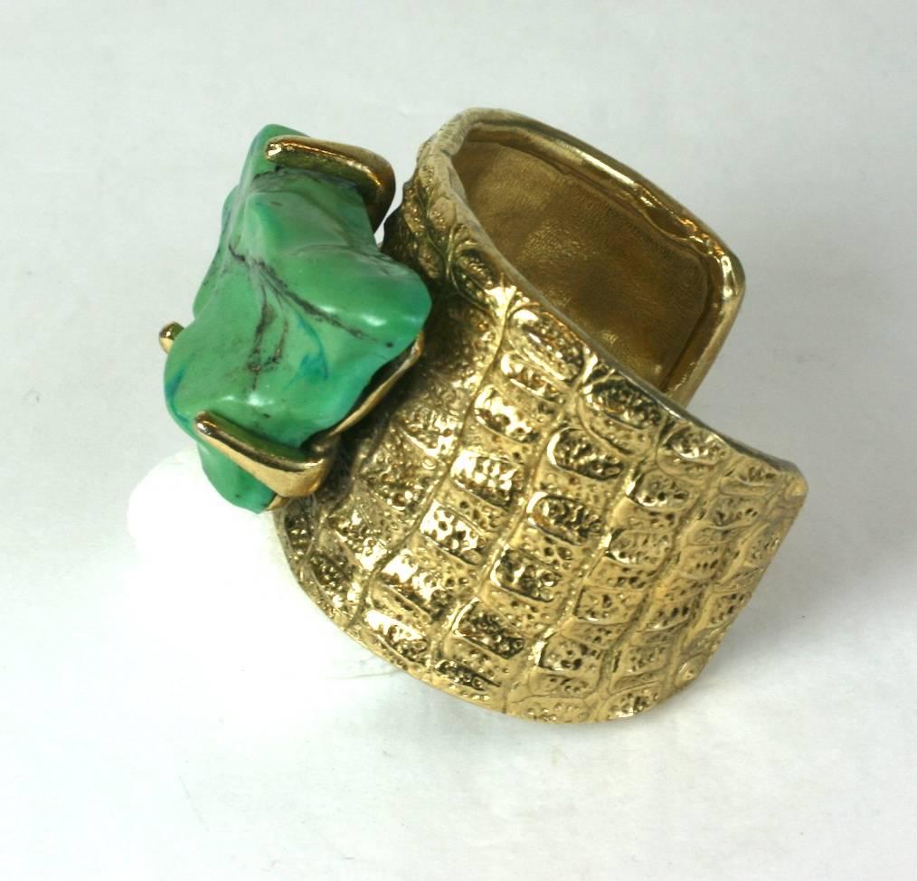 Yves Saint Laurent cuff HC bracelet with faux Tibetan turquoise hand formed pate de verre stone. The body of the cuff of sculpted crocodile skin, a persistent signature motif in Yves Saint Laurent jewels. Workshop of Robert Goossens. Gilded Bronze.