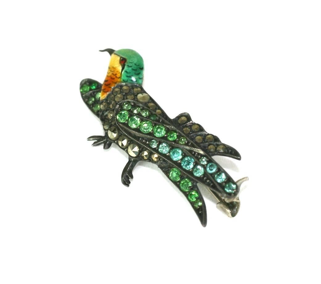 Small but charming Art Deco Marcasite Bird brooch from the 1920's. Exquisite detailing with a finely enameled head, marcasites and faux demantoid green pastes. 1920's USA. Marked 