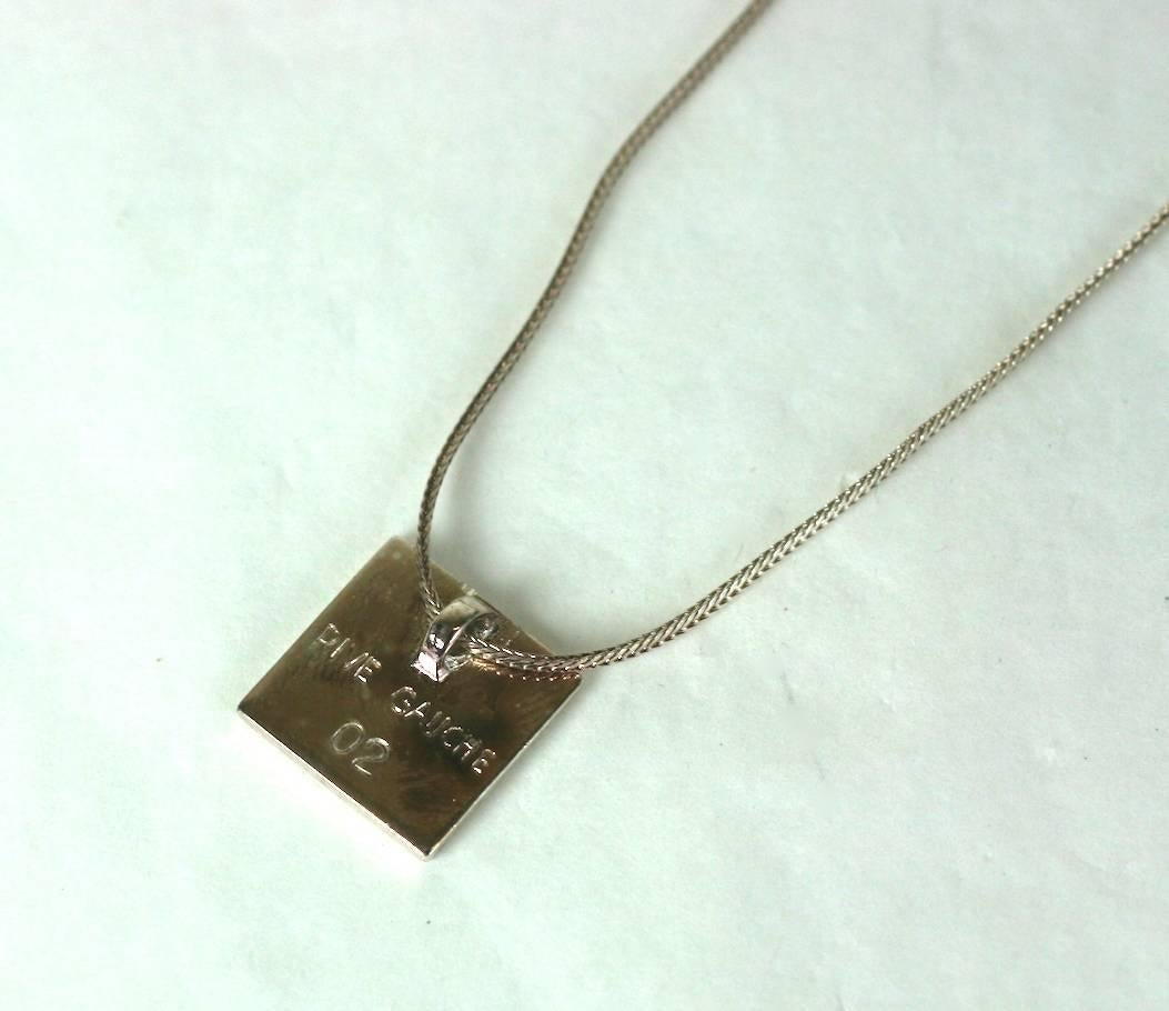 Yves Saint Laurent mens/unisex pendant necklace by Hedi Slimane, Rive Gauche 2003 . Composed of flat chain with focal ivory enamel square pendant, and logo toggle clasp. Excellent Condition
Length 16