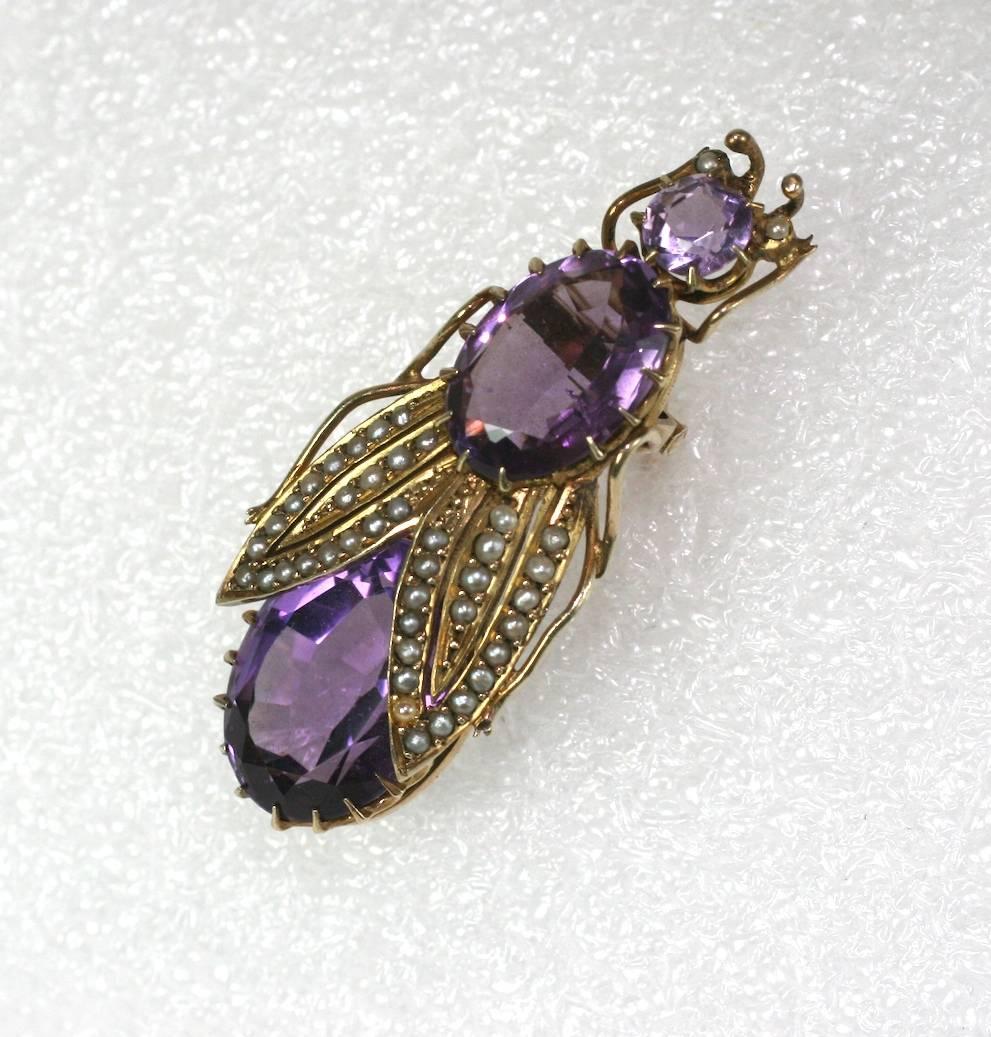Victorian Amythest and Seed Pearl Beetle from the mid 19th Century set in vermeil silver. 2 large oval amethysts are set in high crown settings and form the body, with a smaller round amethyst featured as the head.
The wings have lovely half pearls