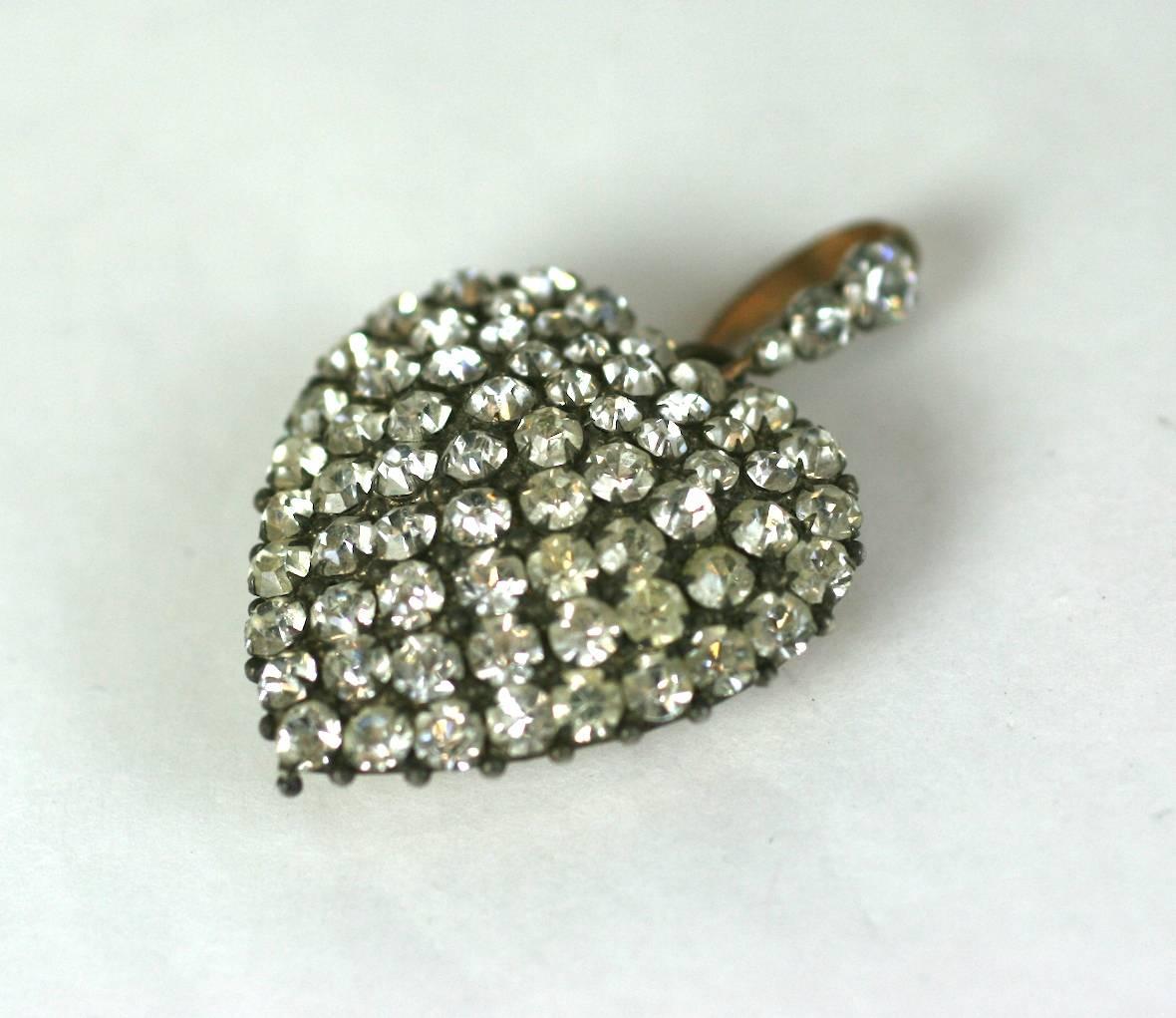 Unusual Victorian gilt metal puffy heart pendant of vari sized, claw set crystal pave. The pendant suspended by a crystal pave bale and has a convex backing. Circa 1880.
Excellent Condition.
Heart measures 1.25
