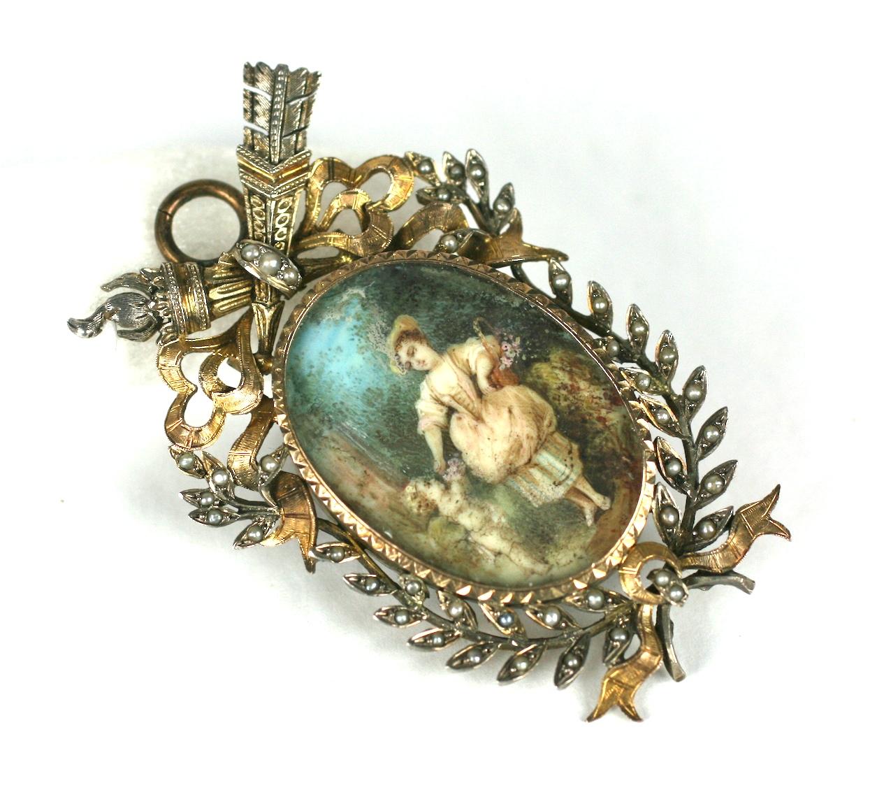 Charming 19th Century Miniature Pendant of a young woman with a cherub set in a wooded clearing, beautifully hand painted and set under glass. Extraordinary detailing in the painted miniature. 
Set in a French style period frame set with seed pearls