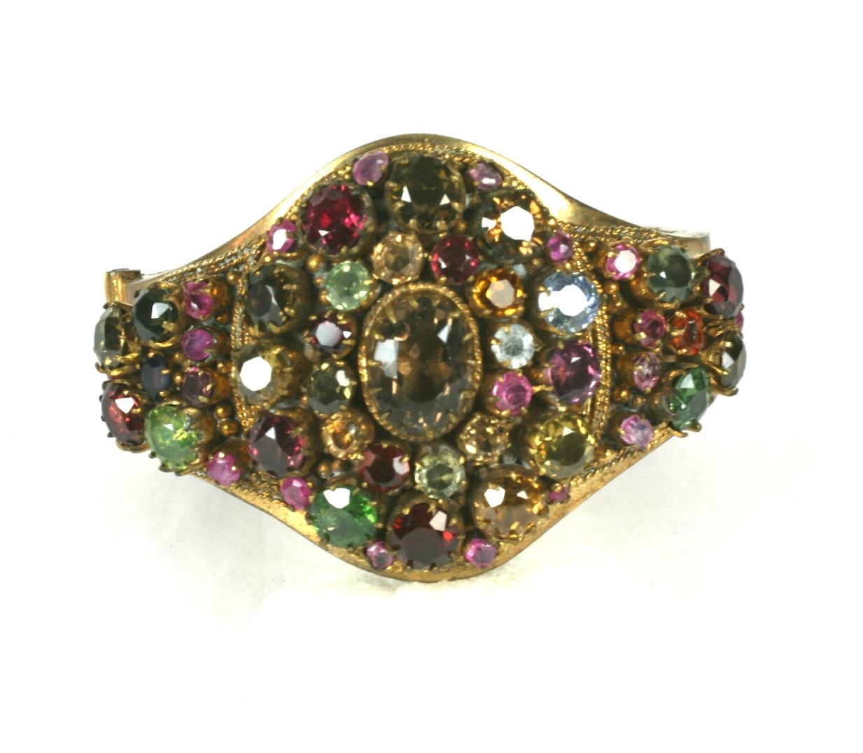 Antique Indian Gem Set Cuff with a colorful array of gemstones mixed with the occasional paste. 
All the stones appear to have foil inserted underneath the settings to magnify the reflection of the gem colors.
A wonderful selection of color stones