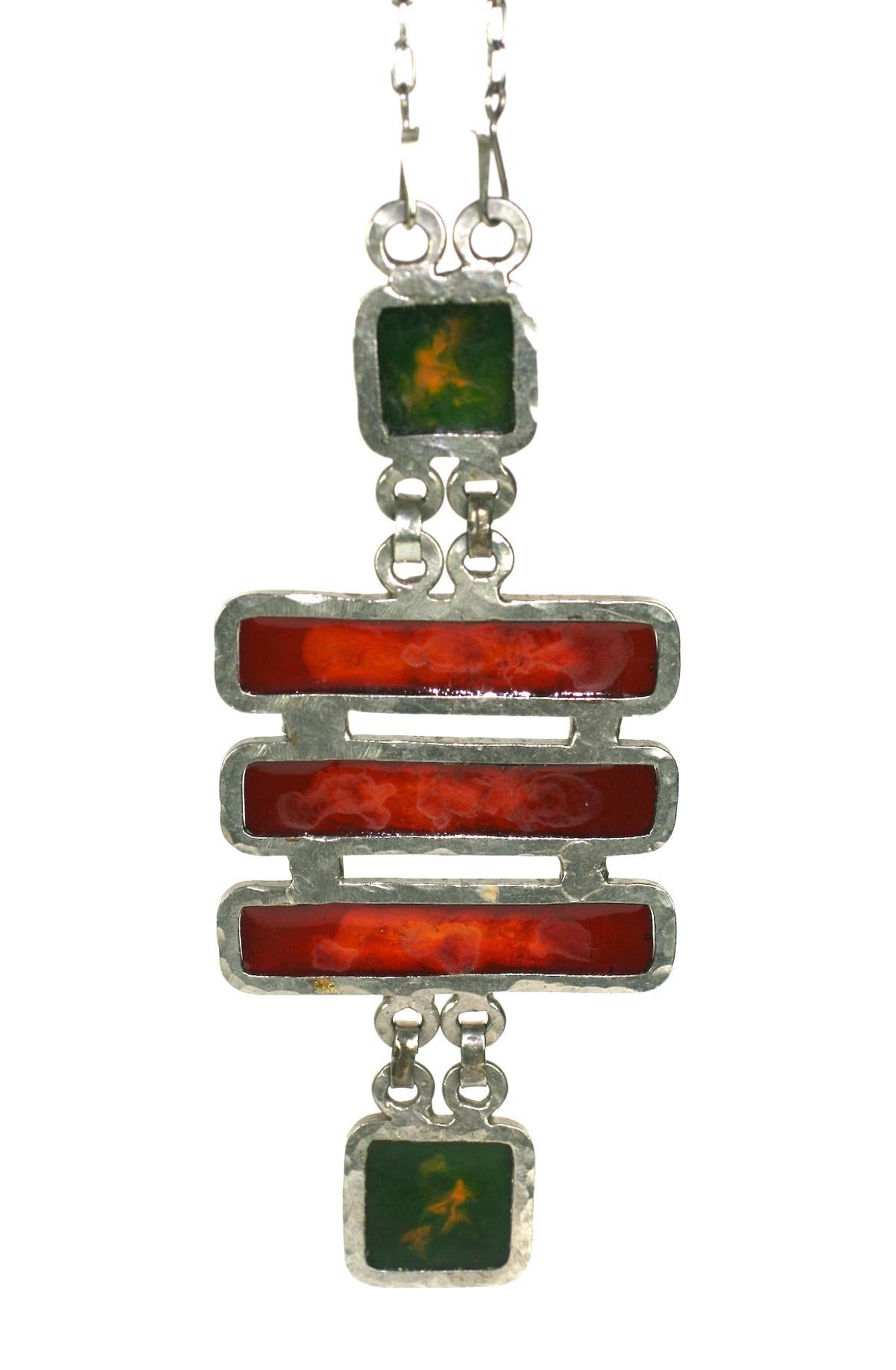 Artisanal Fused Glass Modernist Necklace from the 1960's. Hand crafted white metal bezels are used to form the wells for the molten glass for this Art Deco inspired pendant.
Unusual and striking color combinations of tortoise brown and yellow-green