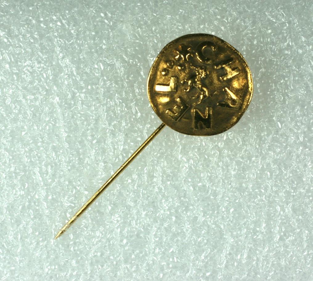 Chanel Logo Stickpin from the 1990's in a coin form with a center Lion motif, representing Chanel's astrological sign. 
Hammered antique gold finish, 1990's France. 
2
