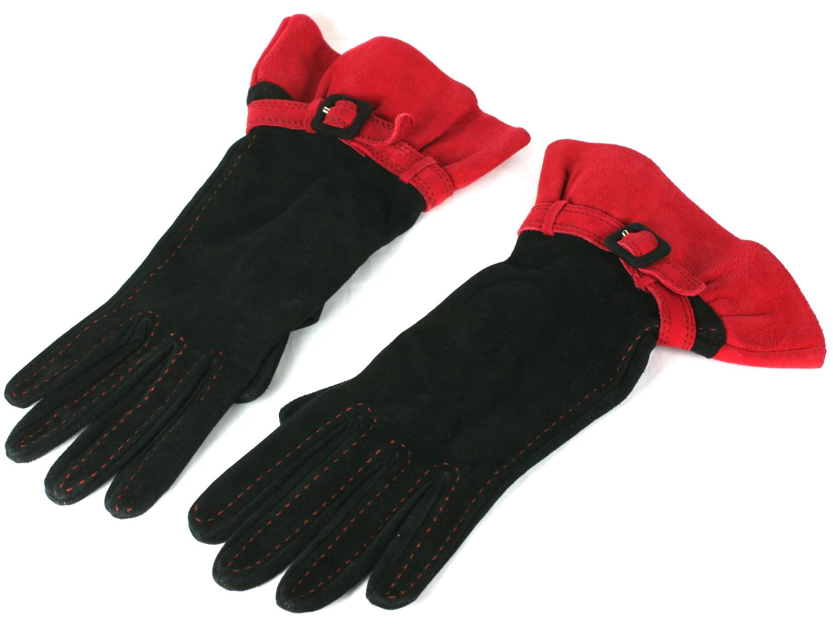 Moschino dramatic black and red suede ruffled gloves. The black suede body of the glove  top stitched in red,  belted at the wrist and ruffled in tomato red suede.
Labeled Moschino , Made in Italy. 
Excellent Condition. 
Size 8, Silk lined. 
Width
