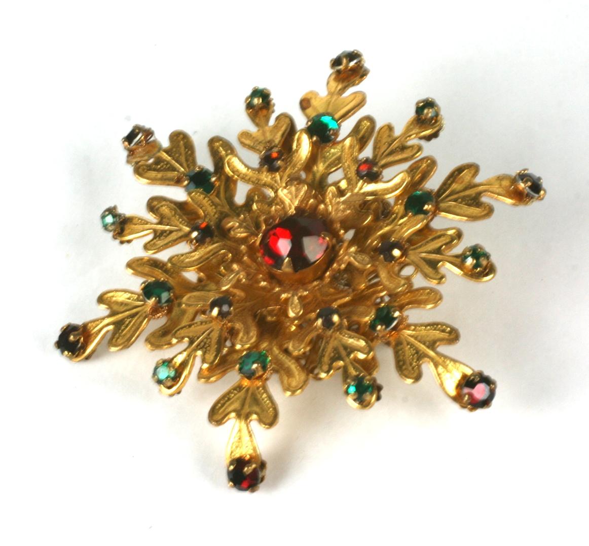 Miriam Haskell Holiday Snowflake Brooch displaying delicate six fold symmetry in signature Russian gilt finish. With with ruby and emerald crystal pastes and large focal round ruby faceted stone.
Excellent condition.
L 2.50