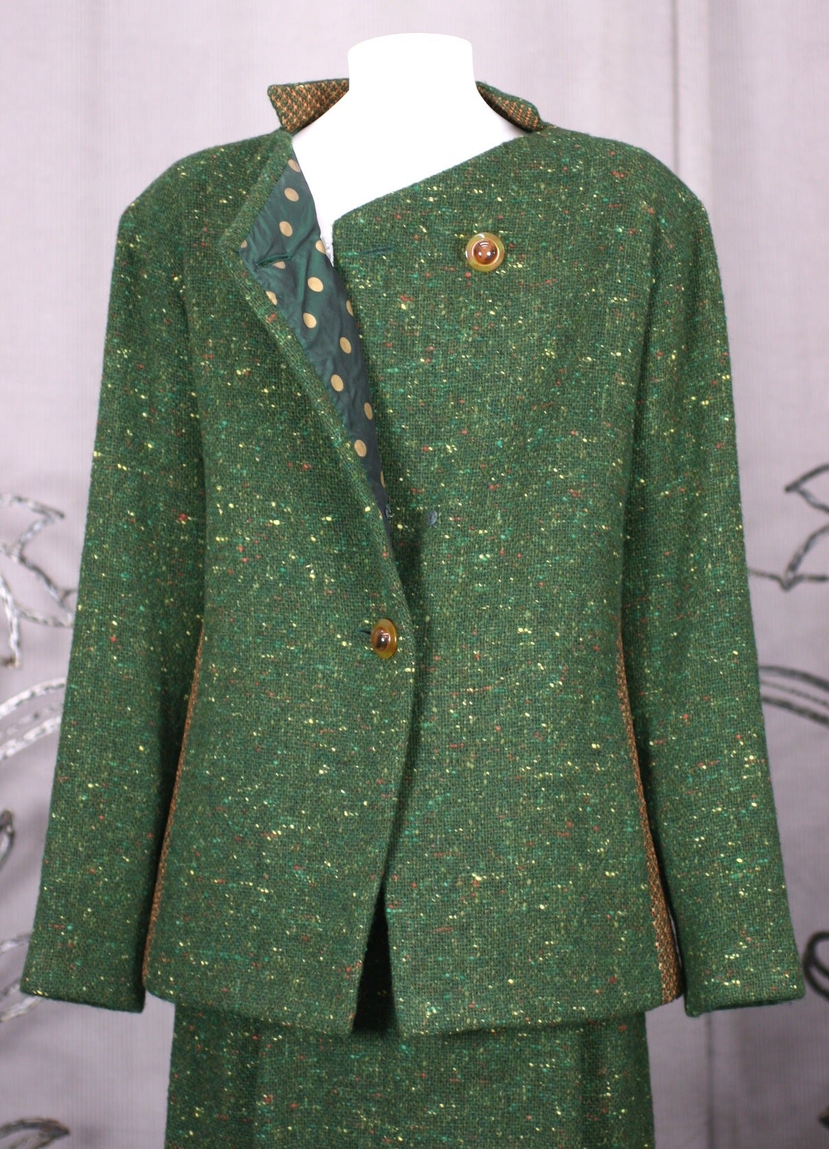 Geoffrey Beene Green Tweed Ensemble with inserts of open weave pink-peach tweed in signature body contouring cuts. Lined completely in green polka dot silk taffeta, Beene approached his sportswear with a luxuriant hand. 
Single pleat slim skirt with