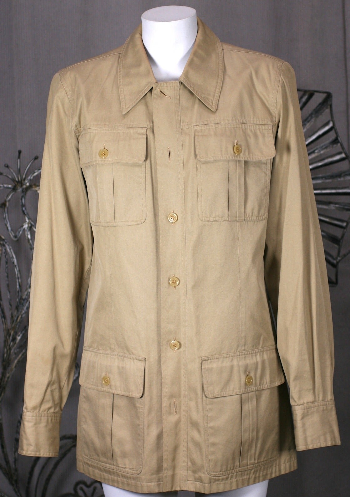 Early Yves Saint Laurent Mens Safari from the 1970's. The Safari became one of  YSL's most iconic designs in khaki cotton twill. 
The men's version of this style is quite rare. Shirt Jacket with 4 patch pleated packets and front button opening.