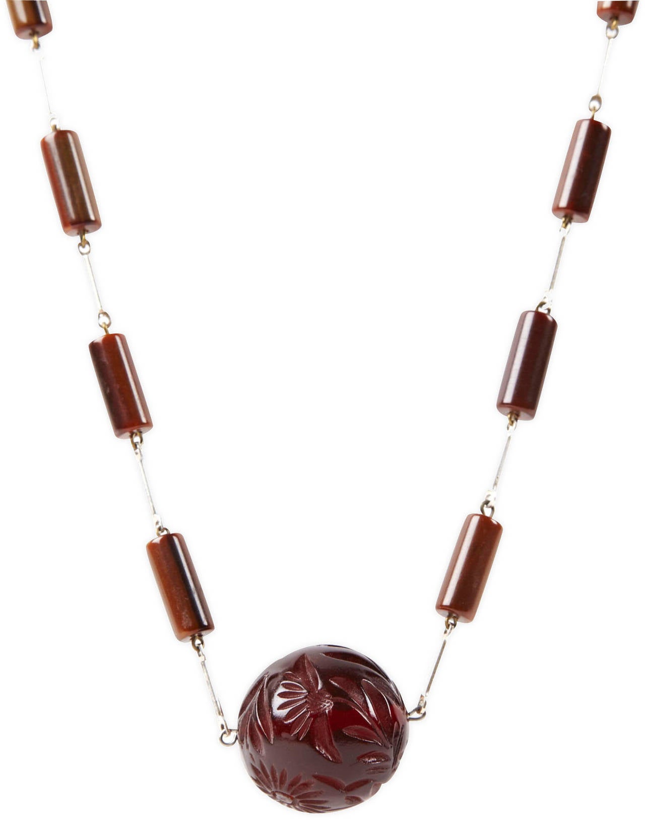 French Art Deco bakelite link necklace in varied shades of brown with chrome link stations. Necklace terminating in a large, floral carved bakelite ruby-brown bead.   Marked, Made In France, Excellent condition. 1920's France. 
Length 32