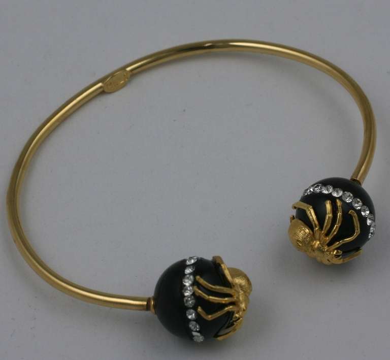 Gilt spider terminals are mounted on onyx beads with a stripe of tiny paste stones to form an unusual bangle. 15 mm terminal beads. Made by hand in France in the studios of Mark Walsh Leslie Chin. Contemporary.