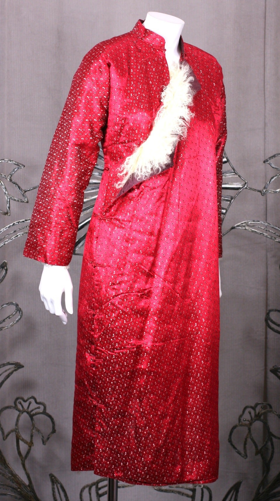 Silk satin brocade Chinese cheongsam from the 1940's with Mongolian lamb lining. Interesting and unusual classic garment designed for cold weather wear. Side frog closures run down right side of garment. 1940's China. 
Excellent condition.

Bust