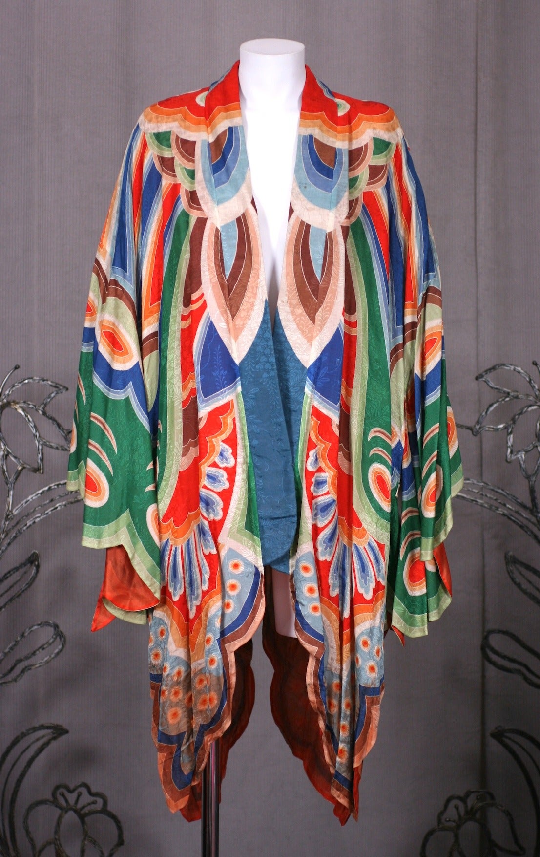 Art Deco Butterfly Kimono style silk dressing gown with incredibly vibrant hand painted graphics. There are a series of interior and exterior ties which are hard to decipher. Incredibly vivid hues transforms wearer into a butterfly, lined in a sheer