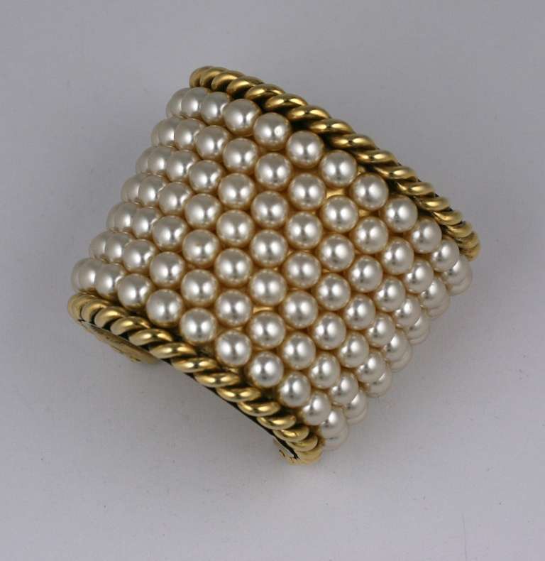 Chanel cuff incorporating rows of Gripoix's iconic pearls wired onto a heavy gilt  bronze base with twisted wire borders. Beautifully handmade in France, 1980's Paris. Karl Lagerfeld for Chanel. Small size.  2.5