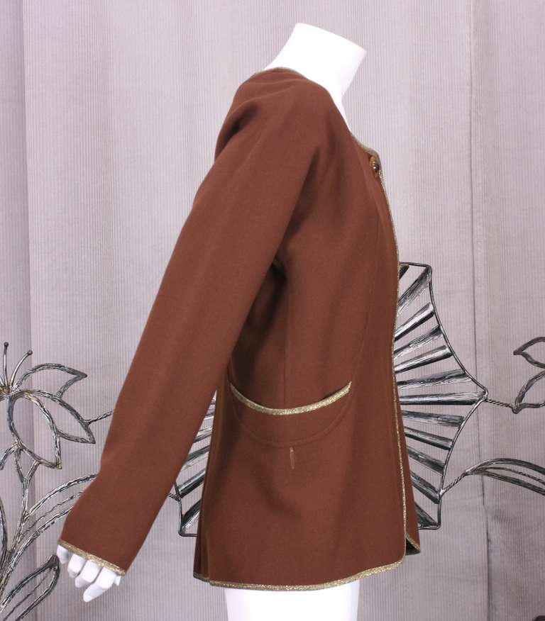 Deceptively simple and chic jacket from master cutter Geoffrey Beene. Deep chestnut double faced wool crepe is trimmed with his unexpected signature... gold lame. His initial training as a doctor figures into the sinous curved seams one sees