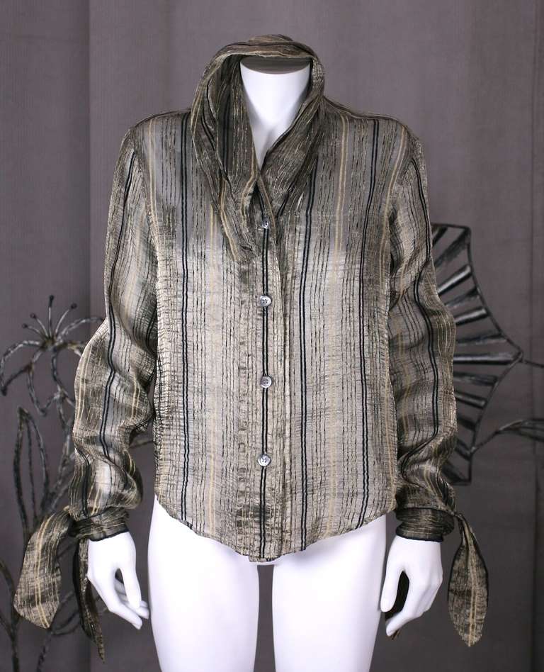 Romeo Gigli's silk metallic organza blouse with signature flourishes such as kerchief tied cuffs and high draped collar. The textile is an Indian striped semi sheer organza.  Collar is draped and slides through itself and rebuttons on front placket.