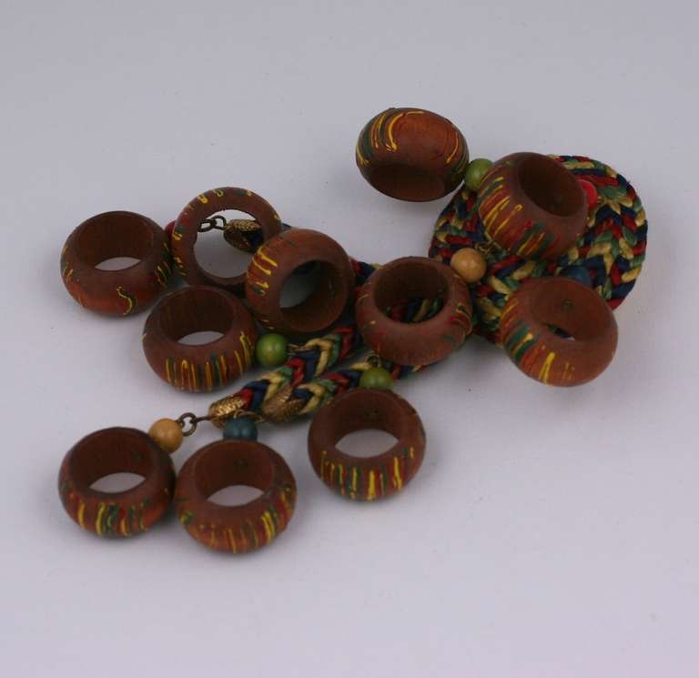 Charming and enormous enameled wood and cord multicolor dangle brooch from the 1930's Czechoslovakia. Wood donuts are enameled in the same tones as the cotton cording from which they hang. Excellent condition. 5.5