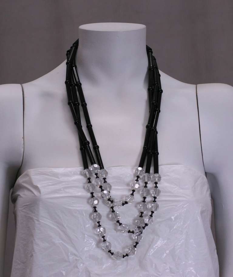 3 strand graduated lucite necklace composed of elongated black barrels and faceted clear lucite beads by Pierre Cardin, Paris. Signature logo clasp. Lengths:  24