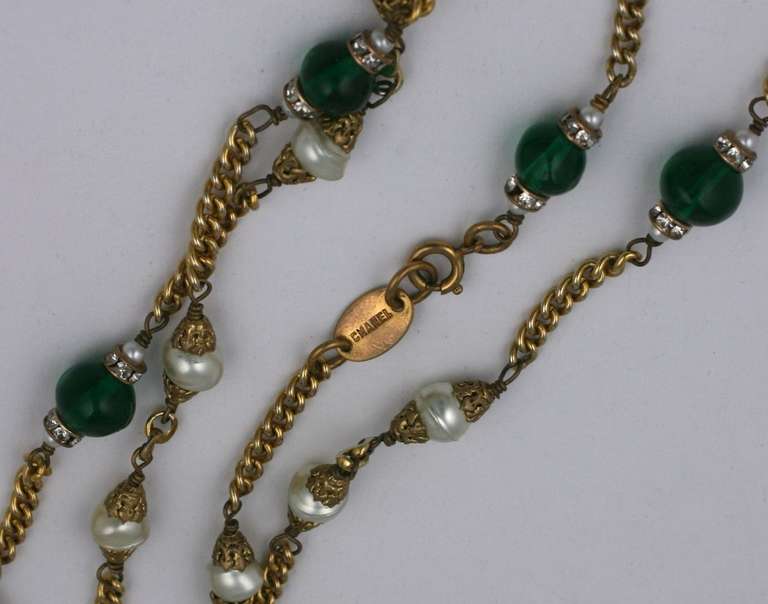 Sautoir by Chanel by Maison Goossens of gilt bronze chaining with emerald pate de verre and faux pearls and rhinestone rondels. France 1970's. Excellent condition.  64