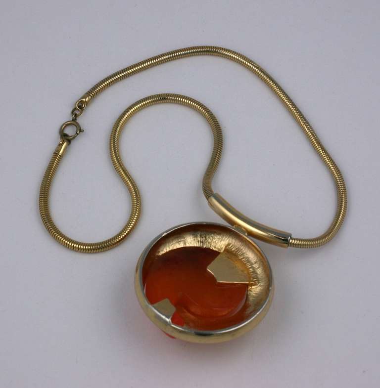 Large mod pendant of caramel bakelite set into gilt metal with thich snake chain. USA 1970s. 20
