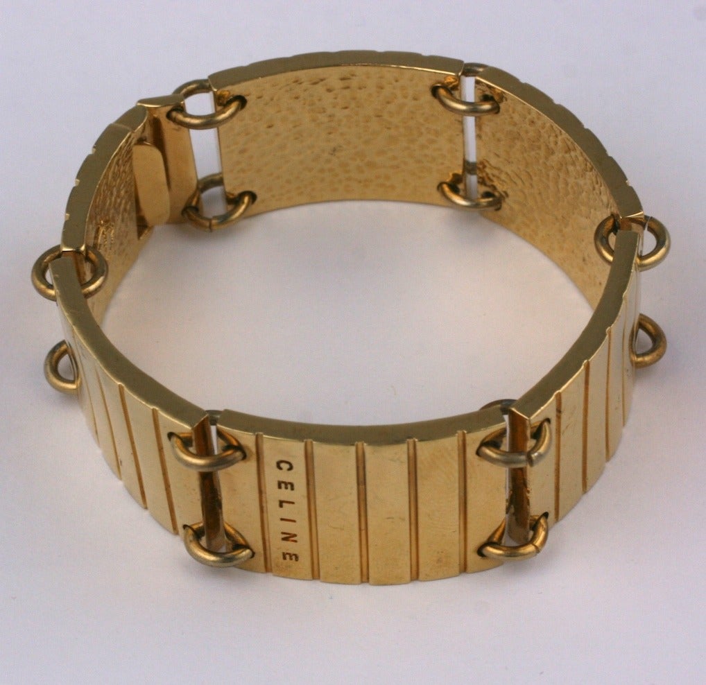 Celine articulated ribbed panel bracelet of 18 kt  gilded metal with alternating panels marked Celine. Signed 