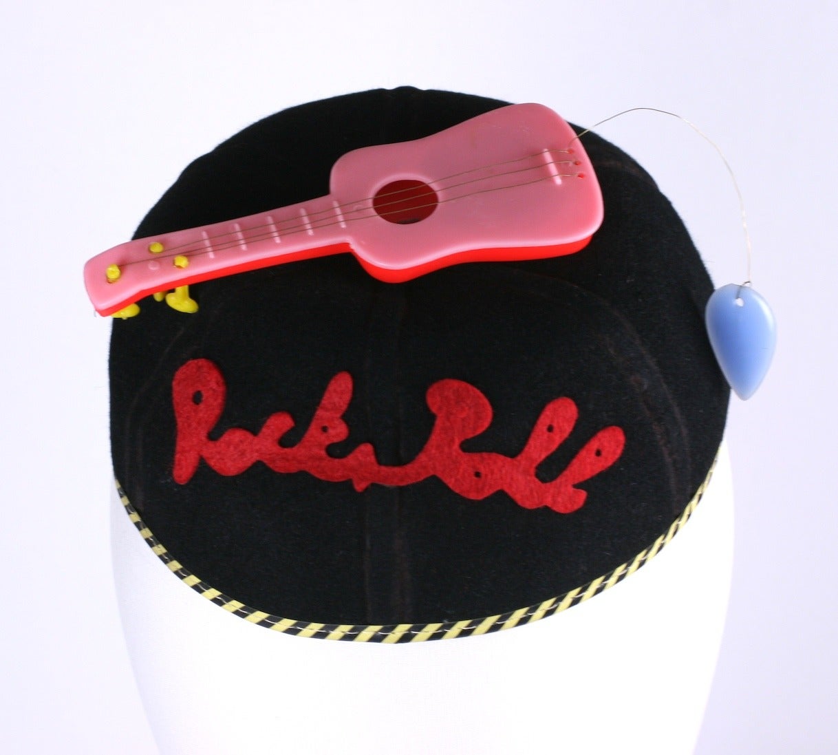 1950's Rock n Roll Beanie of wool felt with applied plastic guitar and 