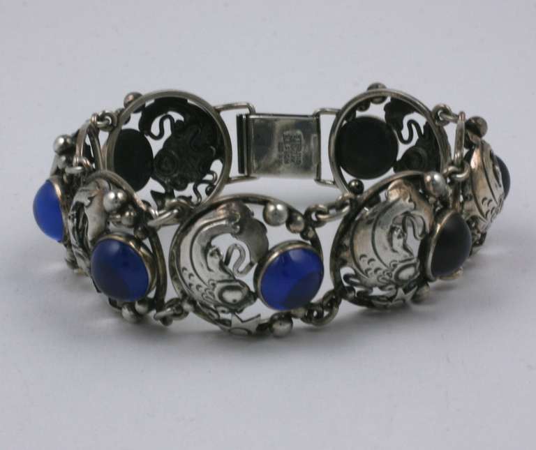 Charming Deco-Retro sterling bracelet with fish and star motifs, hand made and assembled by N.E. From, Denmark. Each fish motif surrounds a blue glass cabochon 