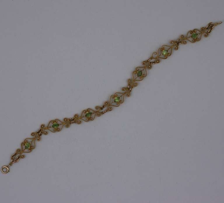 Fine Peridot Art Nouveau Bracelet made circa 1900 of ornate 14k gold wirework and diamond shaped peridots. USA 1900. Excellent condition.