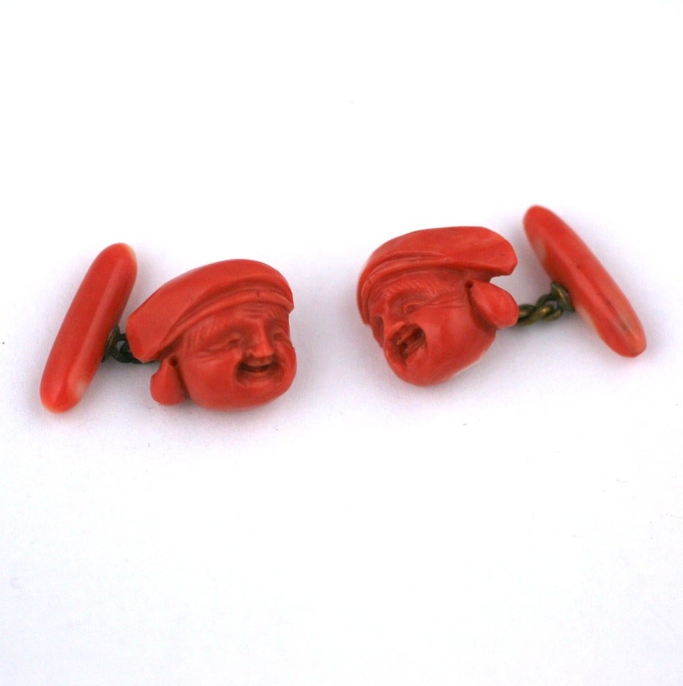 Charming carved genuine coral cufflinks of two smiling Asian profiles attached to coral toggles. Hand carved, beautiful detailing. Asian 1900. 
Each face .75