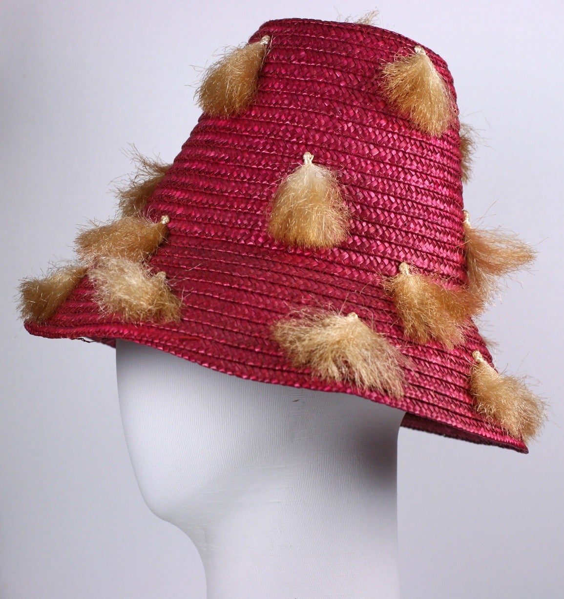 1950's Italian fuschia red woven straw beach hat with tan raffia tassel pom pom  decorations applied all over. Made in Italy. 1950's.
6