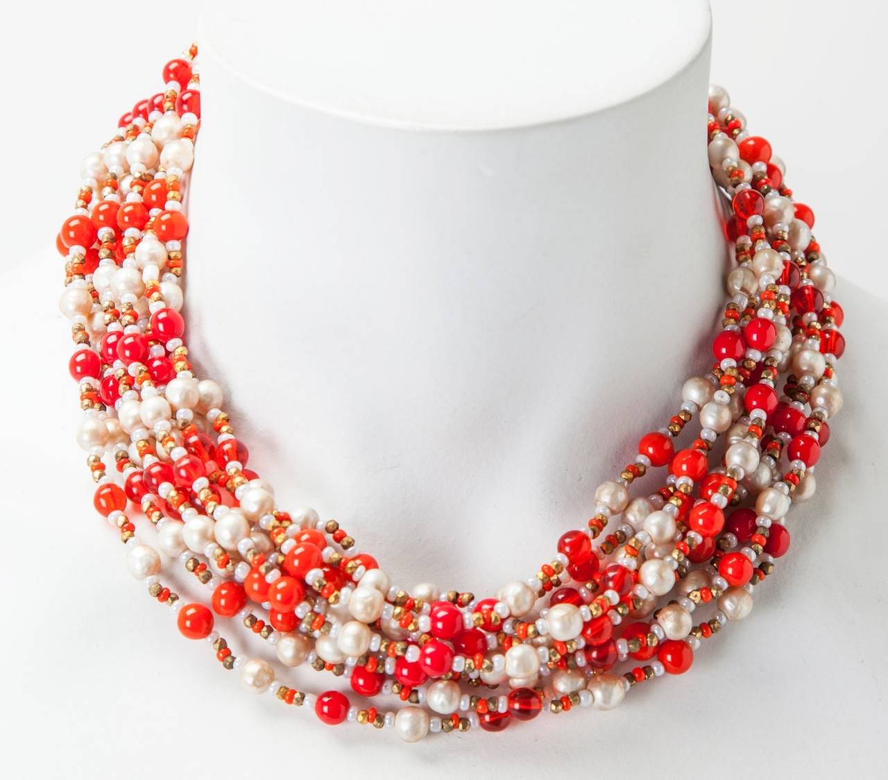 Miriam Haskell 10 strand necklace of signature freshwater faux pearls, tomato red pate de verre round beads in opaque and clear with gilt cut steel bead spacers.  Gold filigree stations and classic flower hook closure. 1950's USA.
Length with bead