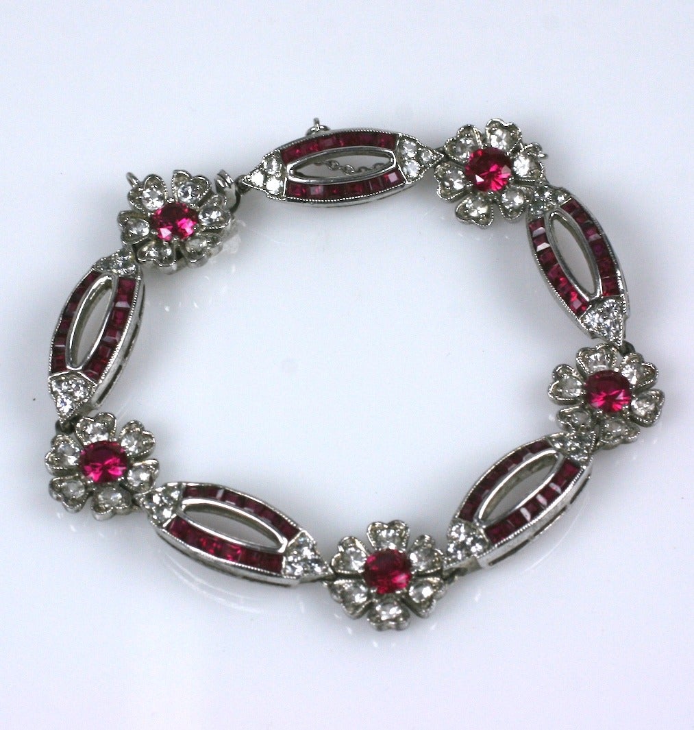 Paste bracelet with fuschia flower heads set in between marquise shaped links of channel set fuschia square pastes. Very attractive and great quality construction. Set in Sterling silver, but, unmarked from the collection of Bunny Mellon. Length: 7