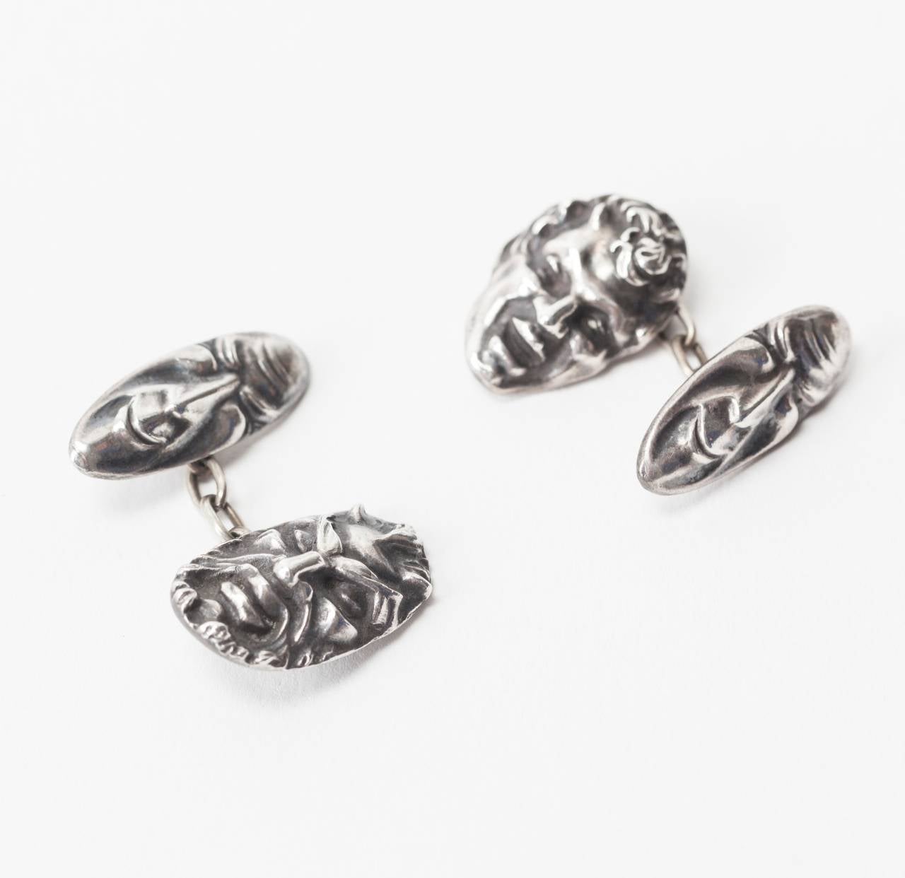 Grotesque mask cufflinks in heavy sterling silver by Etienne David. Little is known about Art Deco designer Etienne David, whose shop was on the Rue de la Paix in Paris in the 1920-30's ,although, he usually worked in the high Art Deco style.
These