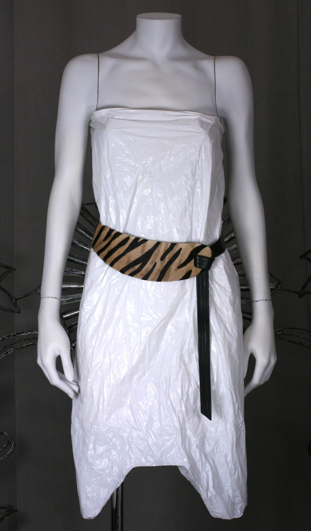 Halston Tiger print belt which loops in signature fashion with a leather tie, like many of the belts made for him by Elsa Peretti. The front lobe shaped panel is pony skin with a tiger print which attached to a black calf leather tie which can be