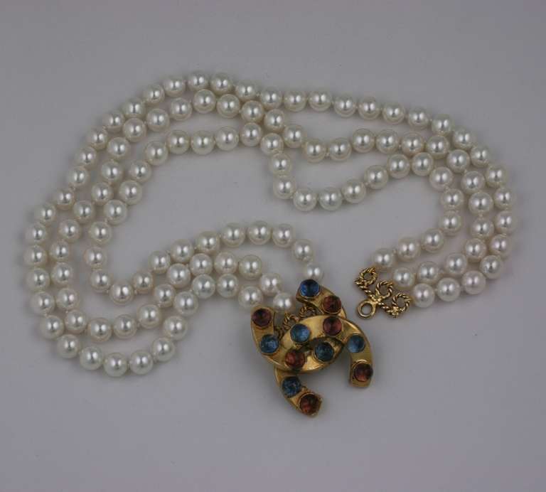 Chanel's 3 strand hand knotted  faux pearl necklace with Gripoix's poured glass clasp of interlocking 