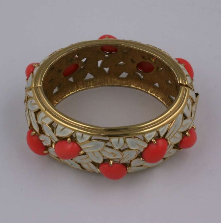 Lovely Jomaz cuff of pierced gilt metal with white enamel leaves and coral glass cabochons. Hinge side opening. Excellent condition 1970's USA.
Interior diameter 2.5 x 1.75