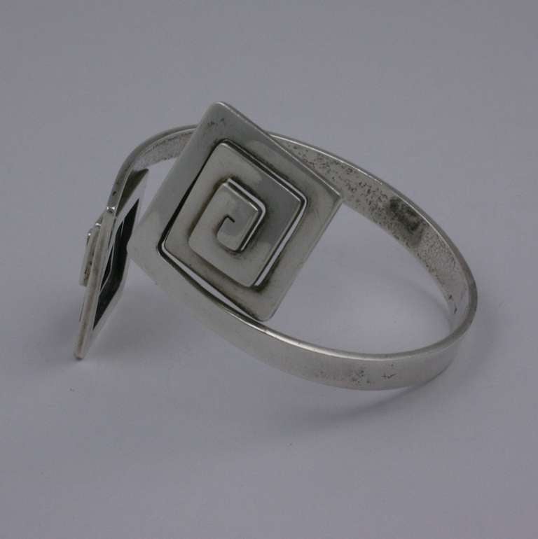 Greek Key Modernist Cuff by Puig Doria, Spain. Heavy gauge sterling is handcut into crossover Greek Key terminals which can be adjusted by squeezing bracelet band> Elegant and striking. Spain 1970's. Excellent condition.    Interior diameter 2.5