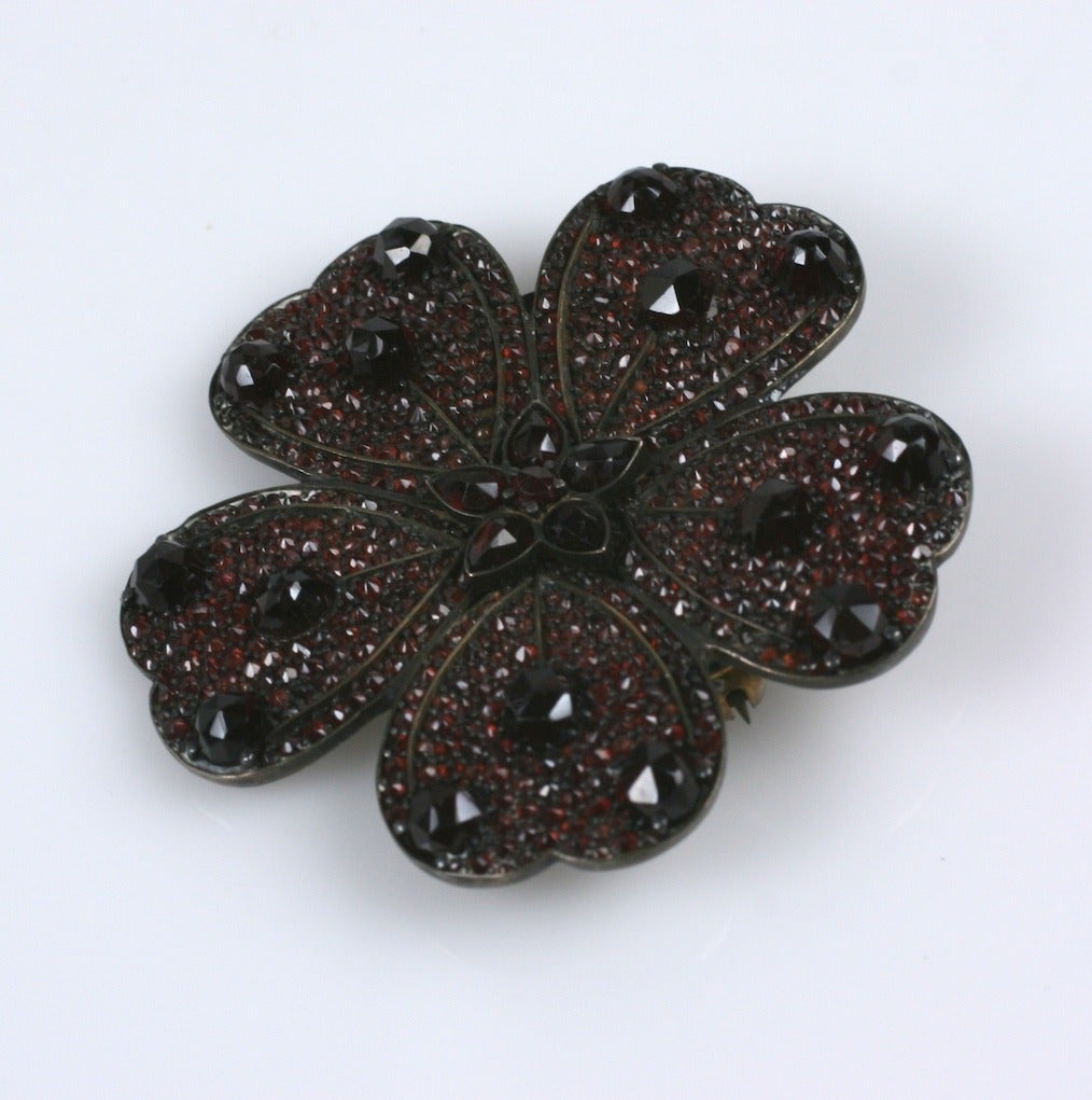 Victorian Garnet Pave Pansy Brooch from the late 19th Century. Incredibly tiny garnets are set into the base of the brooch and is accented with rose cut bullet  and pear shaped garnets as well. Very striking, dimensional brooch. 
1870's USA. Period