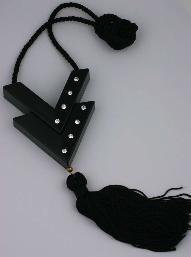 Iconic pendant from Valentino in black bakelite decorated with Swarovski crystals, a silk tassel and cord. The 2 