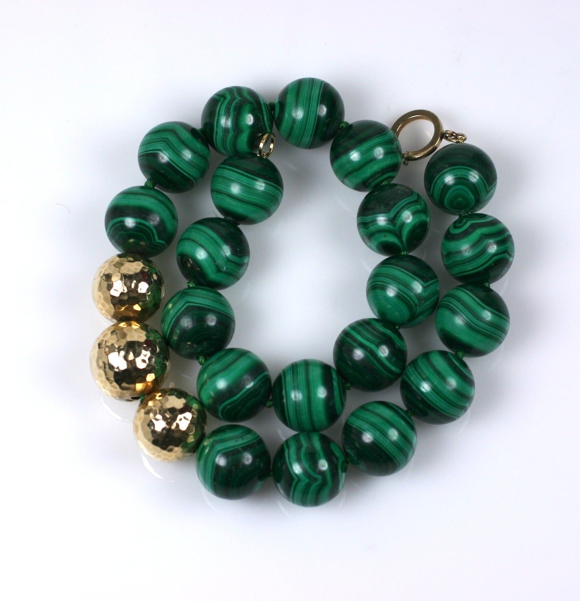 Oversized hand knotted Malachite beads are accented with 3 large hammered 14k gold beads. Attractive and wearable classic. Beads 20mm. Length 20