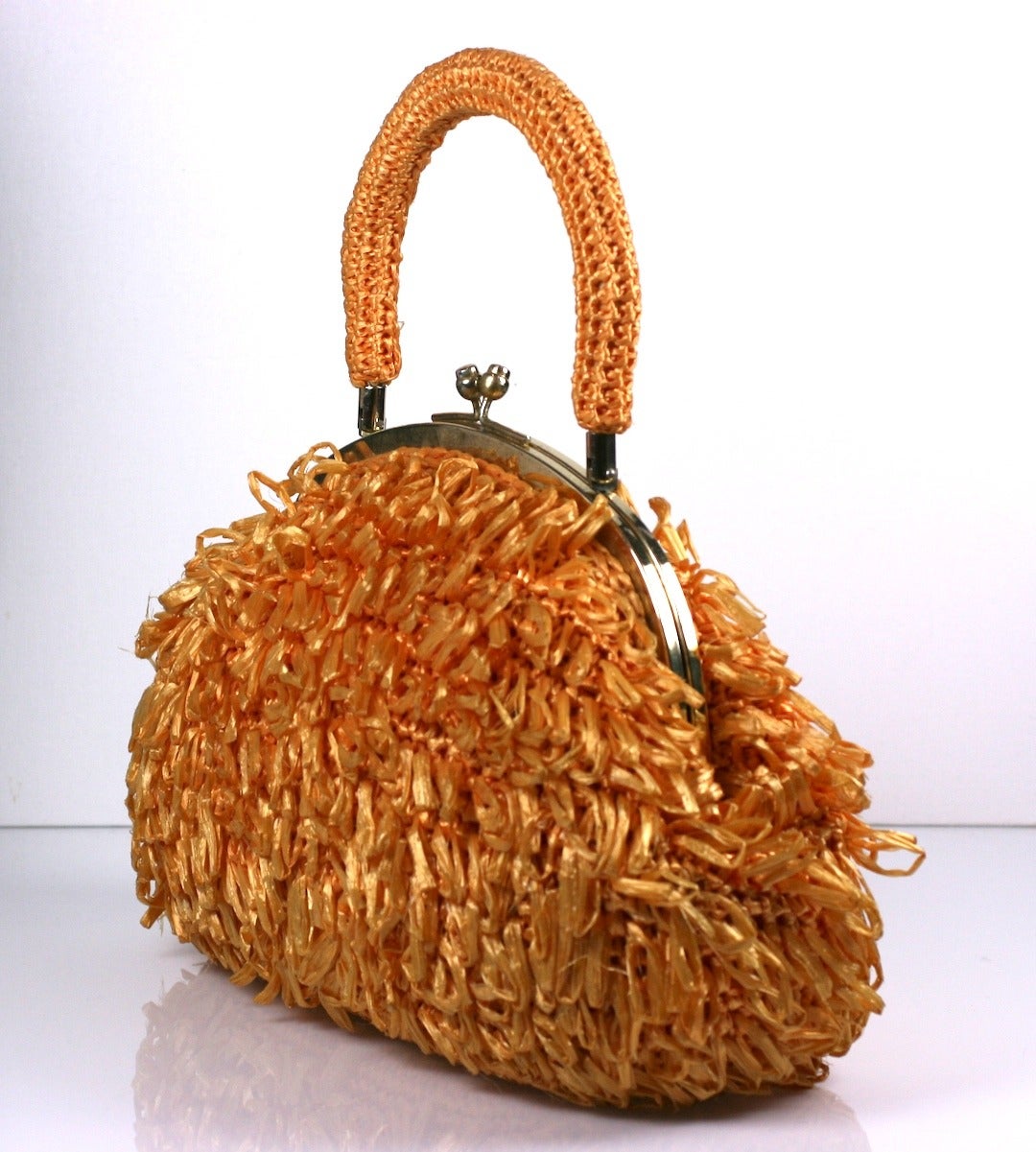 Mod orange sherbert textured bag in looped raffia from the 1960's Japan. Completely hand crochet with matching crochet handle. Bag 14