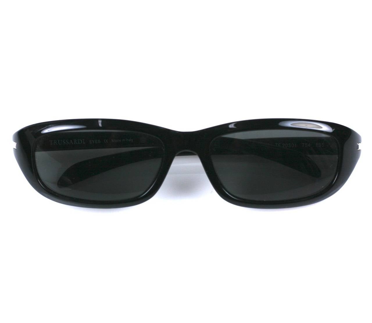 Trussardi sunglasses with signature logo on arm. 6