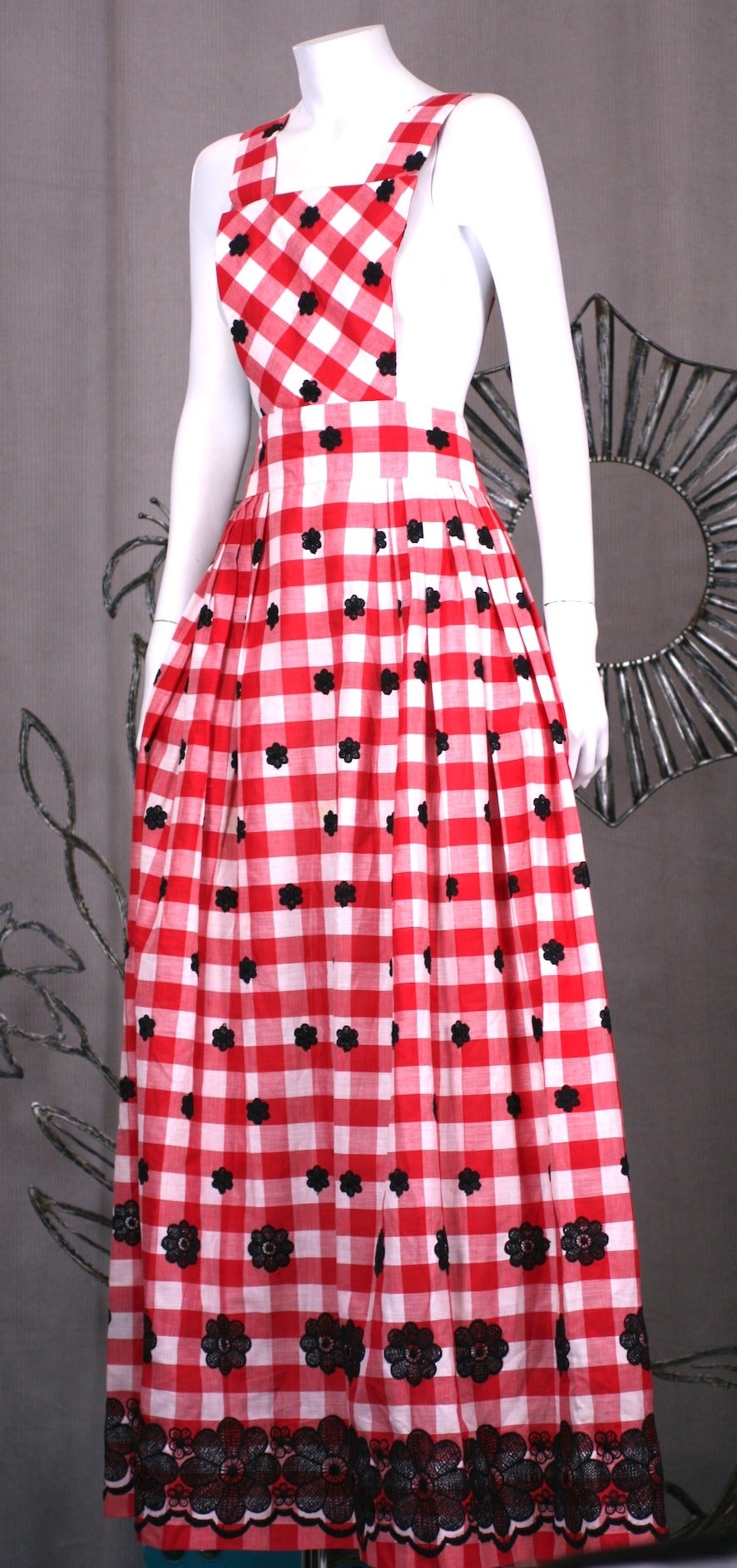 Charming cotton gingham pinafore hostess maxi with black Schiffli floral embroidery.  Straps button at waist back, can be adjusted to size. 
Dressmaker quality, 1960's USA.   Waist 26