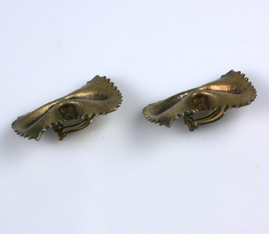 Sterling vermeil ear clips in the form of bow tie pasta. Charming conversation pieces.    Unmarked. Excellent condition. 1980's USA.  
1.75